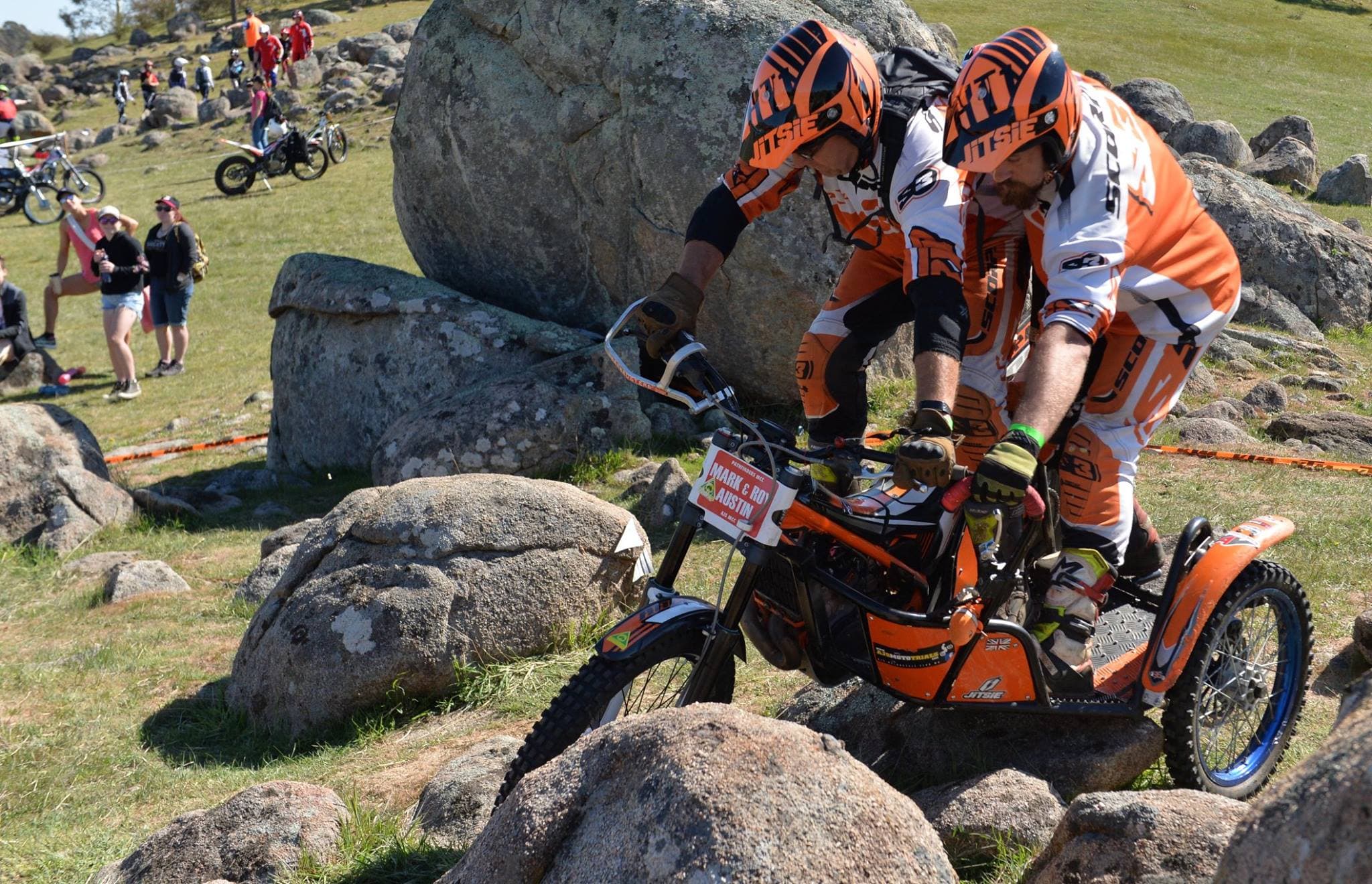 Sidecar trials outfit with rider and passenger navigating a section together